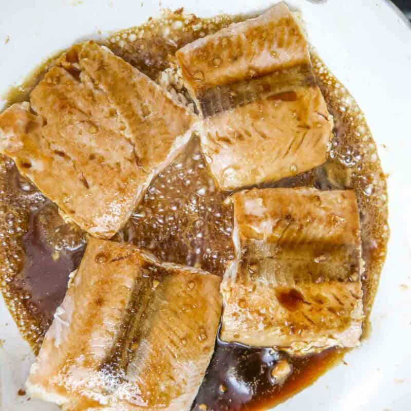 Overhead view of process shot 4 - pour the soy sauce and brown sugar mixture over the salmon fillets. Cook until the sauce has thickened and the salmon is done, about 2-4 more minutes.