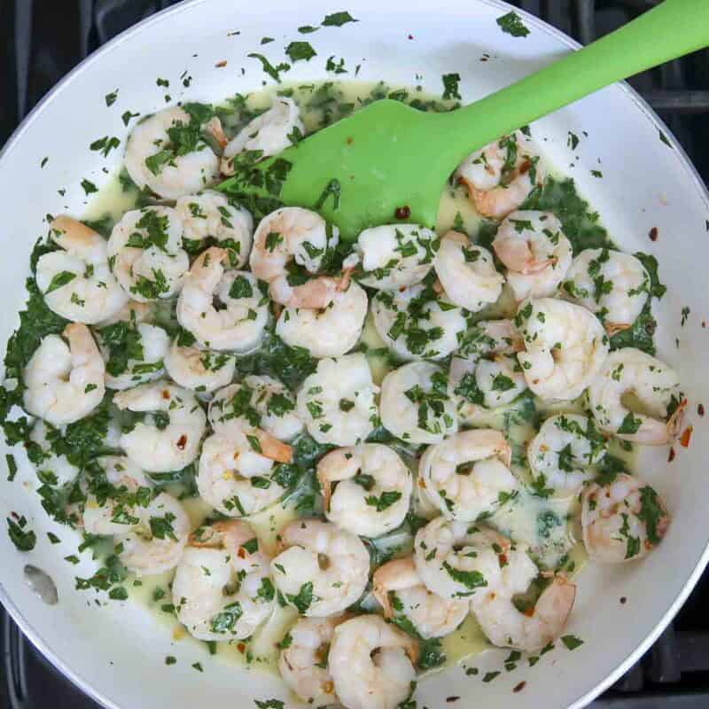 Overhead view of process shot 3 - add the remaining butter and cilantro, and toss.