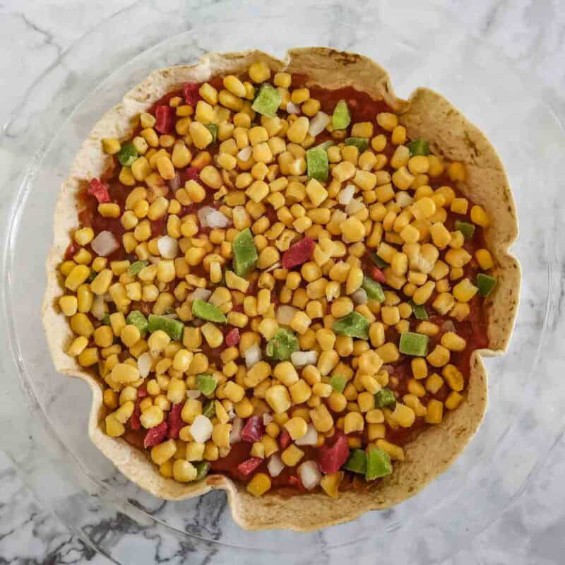 Overhead view of process shot 2 - distribute about half of the corn evenly on top.