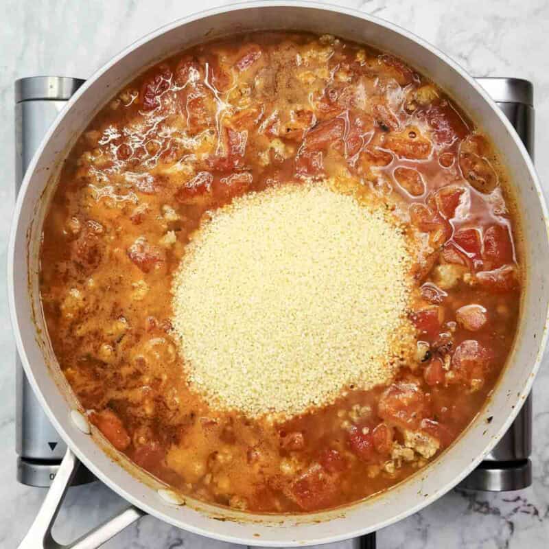Overhead view of process shot 4 - Stir in the couscous, cover, remove from the heat, and let stand for 5 minutes.