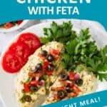 Overhead shot of two mediteranean chicken breasts with fresh cilantro and tomato slices on the side on a white plate.