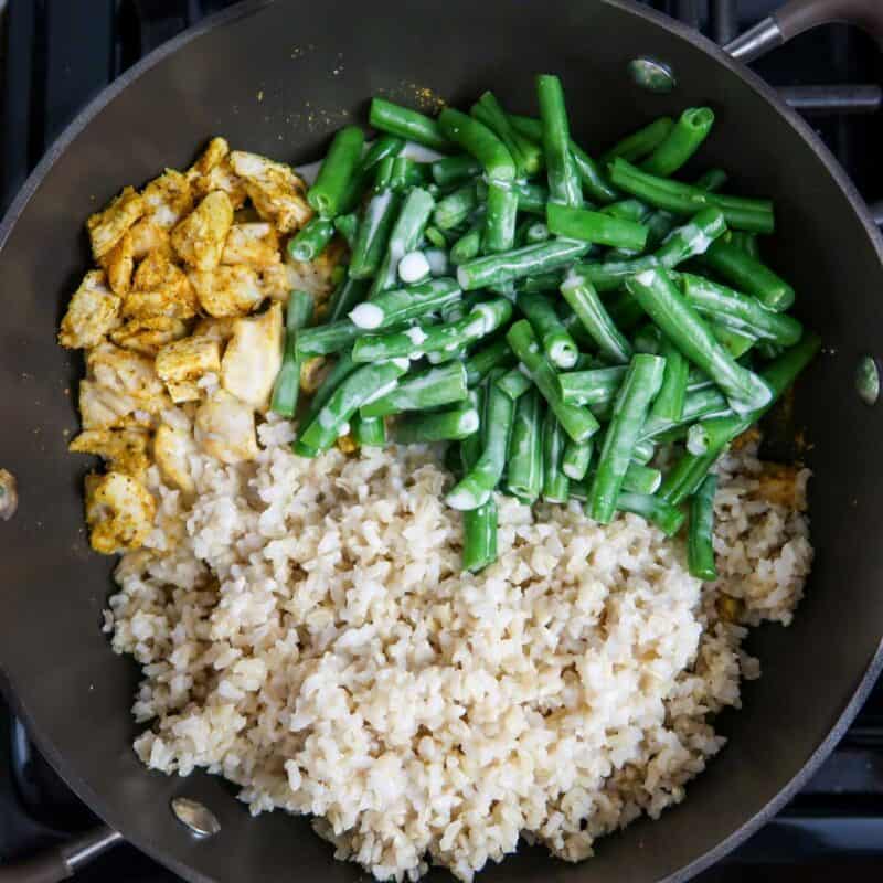 Overhead view of process shot 2 - add rice, green beans, and coconut milk.