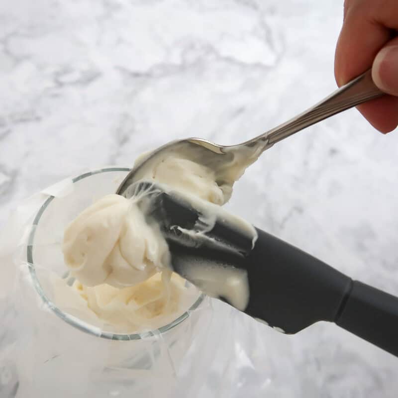 Overhead view of process shot 5 - melt the white chocolate chips and spoon it into a candy decorating bag.