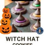 Side shot of witch hat cookies on a baking sheet with a spider decoration in the background.
