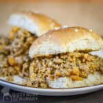 Close up side shot of two veggie sloppy joes on a white plate.