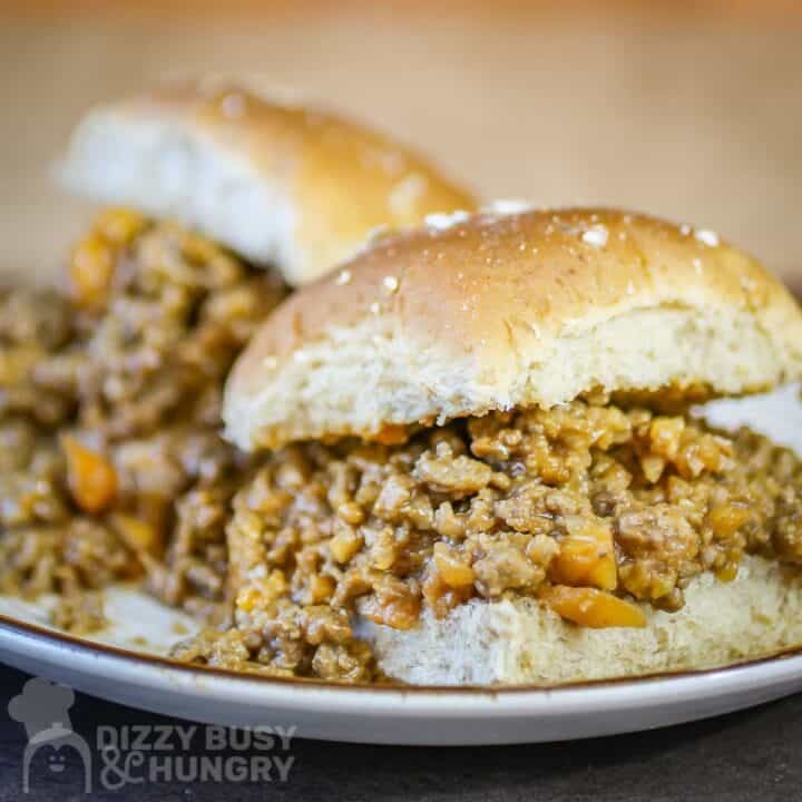 Close up side shot of two veggie sloppy joes on a white plate.