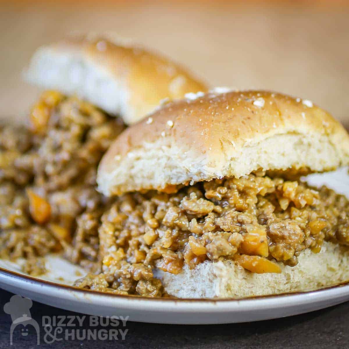 Close up side shot of two veggie sloppy joes on a white plate.