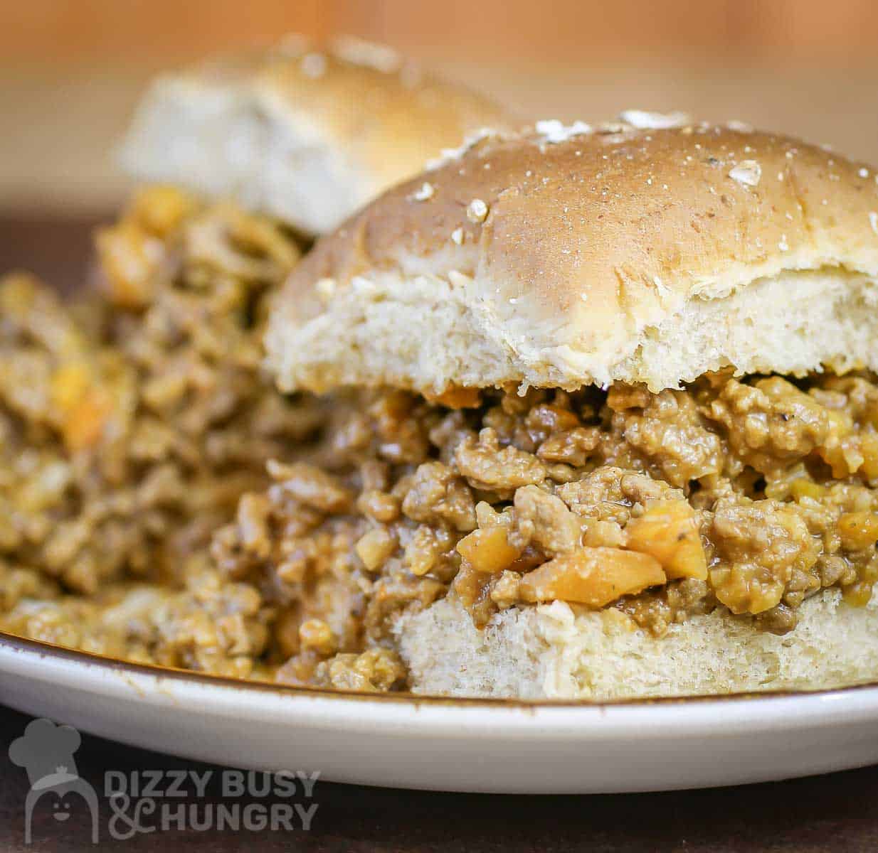 Close up side shot of two veggie sloppy joes on a white plate.