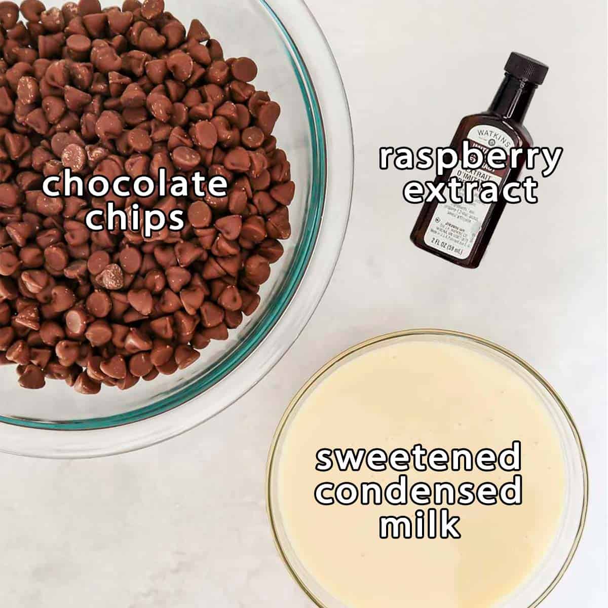 Overhead shot of ingredients - chocolate chips, sweetened condensed milk, and raspberry extract.