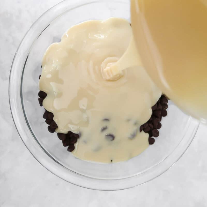 Overhead view of process shot 1 - place the chocolate chips and sweetened condensed milk in a microwave safe bowl.