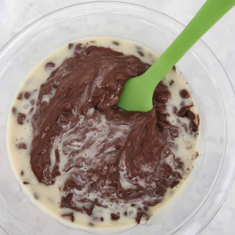 Overhead view of process shot 2 - microwave on high for 1 minute and stir. If needed, microwave again, 20-30 seconds at a time, stirring in between, until all the chocolate chips are melted.