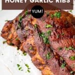 Glistening pork ribs garnished with chopped parsley.